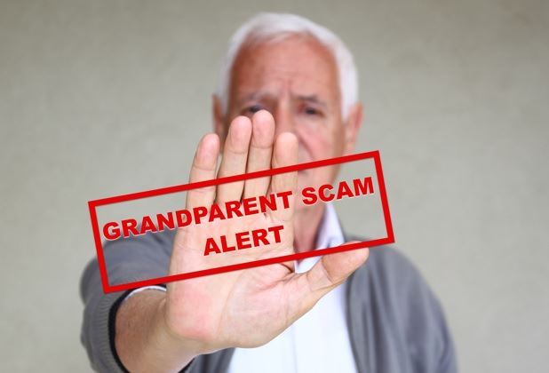 Older man holds out his hand in a stop gesture with Grandparent Scam alert over it.