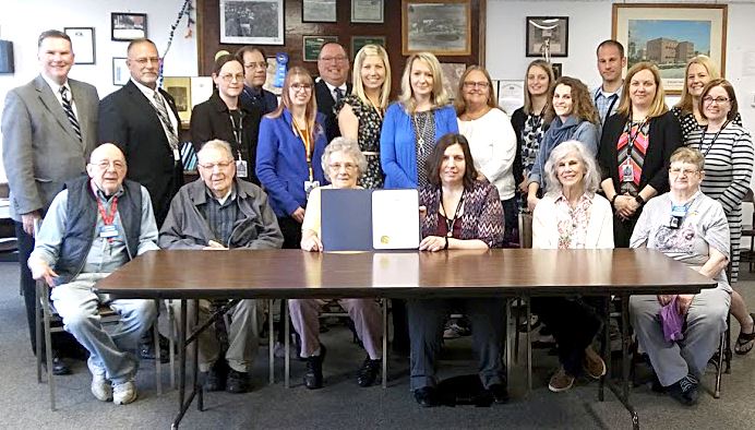 A group of Senior Citizens and Area Agency on Aging staff members pose with the County Commissioners