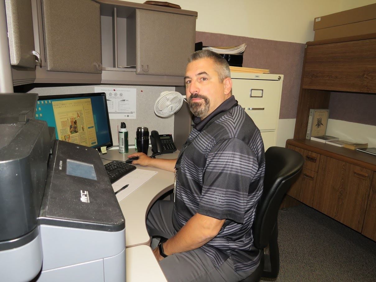 Director of Military & Veterans Affairs Harry Young seated at his desk at the Area Agency on Aging.