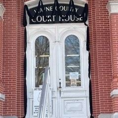 An image of the door to the County Courthouse draped in black bunting for the late Mark Graziadio.