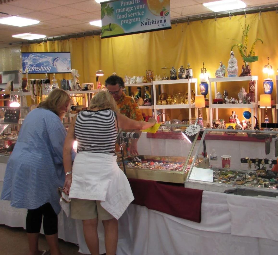 Two women looking at antiques a that Women's Club of Honesdale's annual July show and sale.