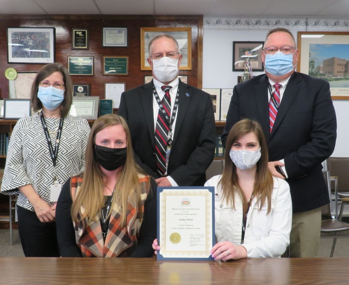 Haley Bond with the Commissioners marking one year of service to the people of Wayne County.