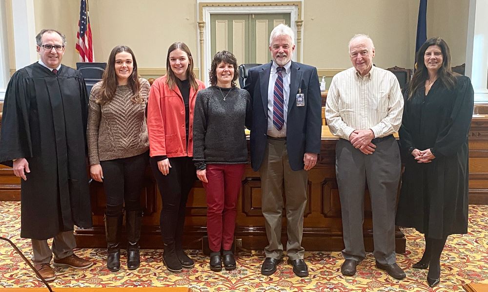 James Shook and family with County Judges Janine Edwards and Matthew Meagher.